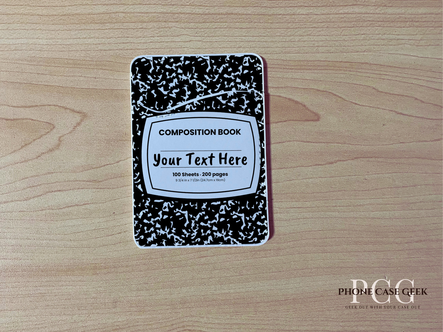 Custom adhesive phone wallet/card holder with black and white composition notebook design on a wooden surface.