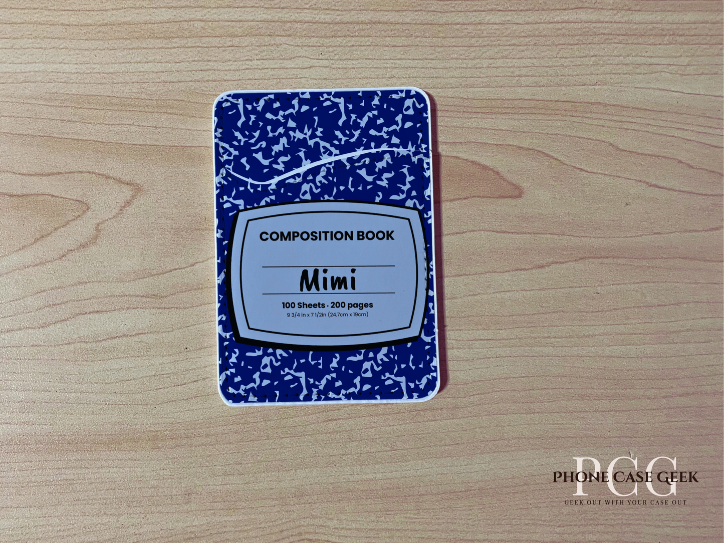 Custom phone wallet/card holder with blue and white composition notebook design with "Mimi" text on a wooden surface