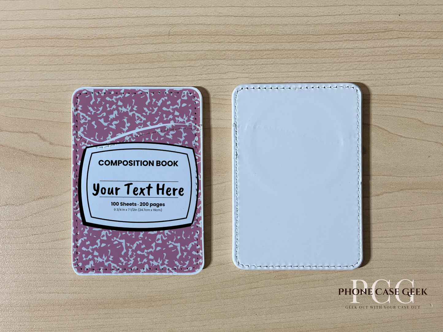 Custom Magsafe phone wallet/card holder with pink and white composition notebook design on a wooden surface.