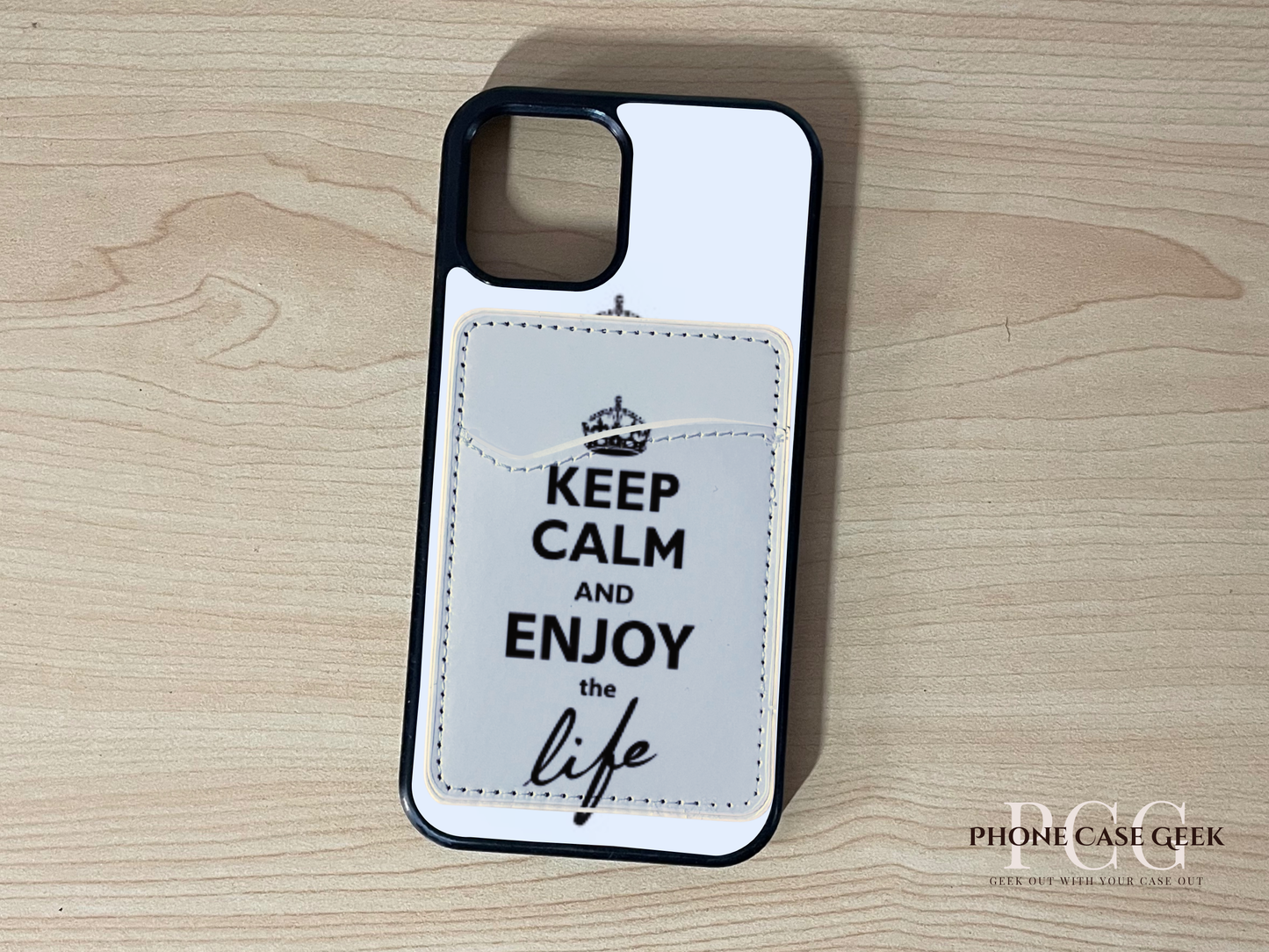 Custom phone case with 'Keep Calm and Enjoy the Life' text with matching phone wallet/card holder on a wooden surface