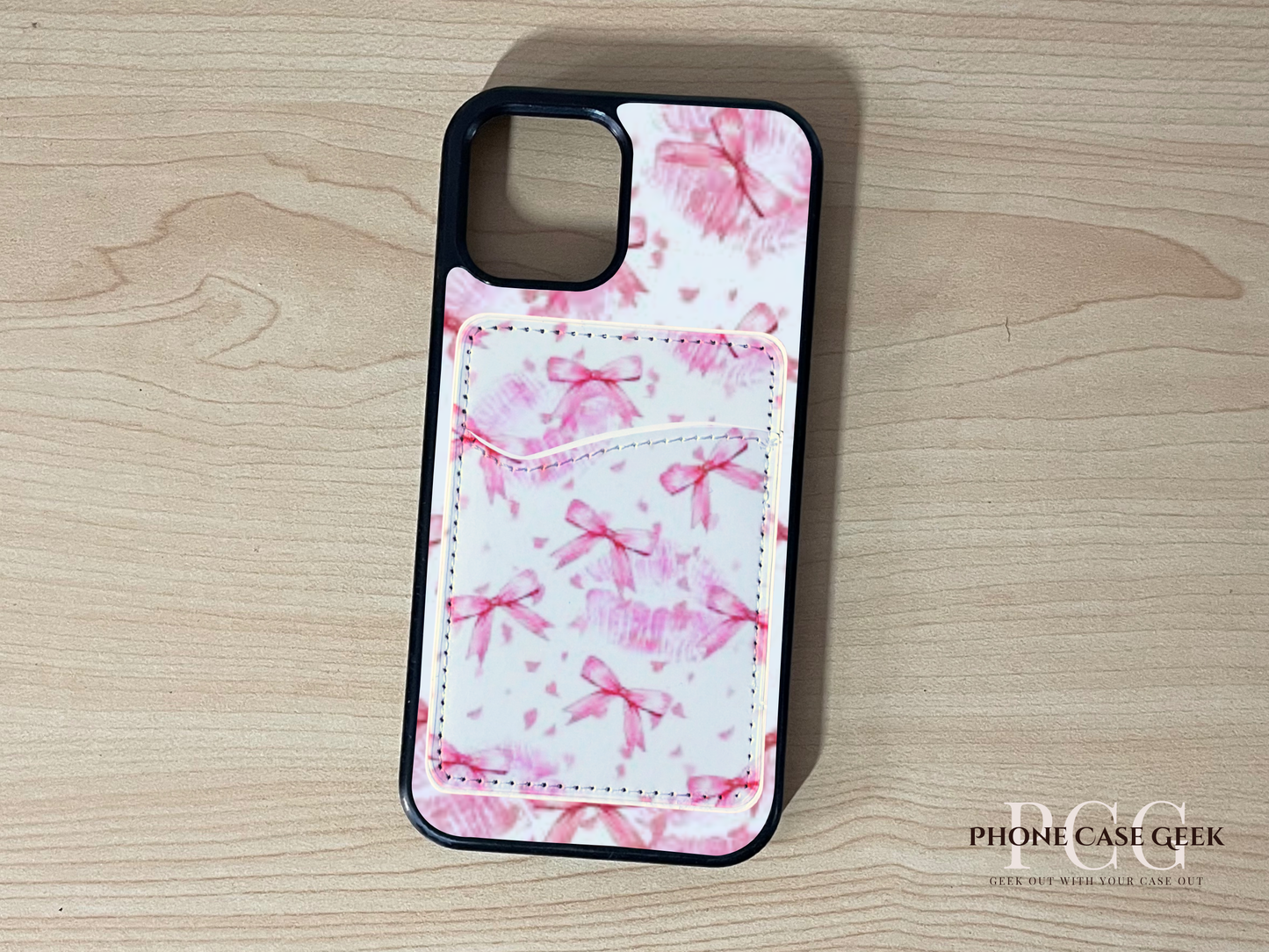 Custom phone case with pink bows pattern with matching wallet/card holder on a wooden surface