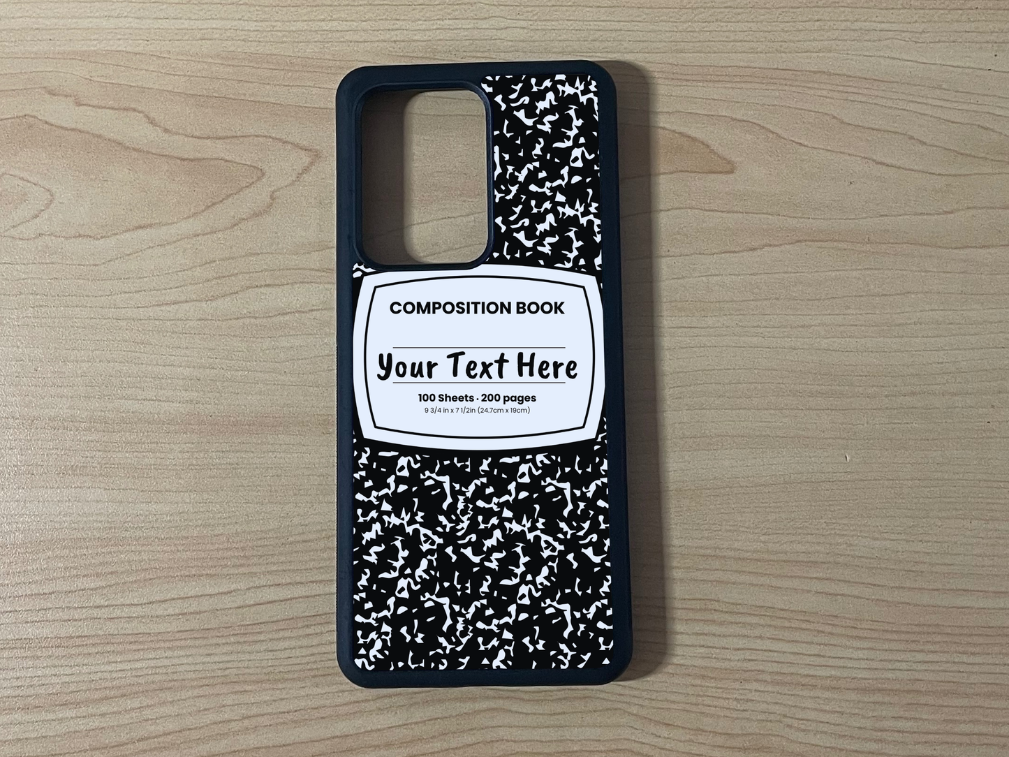 Custom phone case for the Samsung Note 20 and Note 20 Ultra with a black and white composition notebook design with text "Your text here" on a wooden surface.