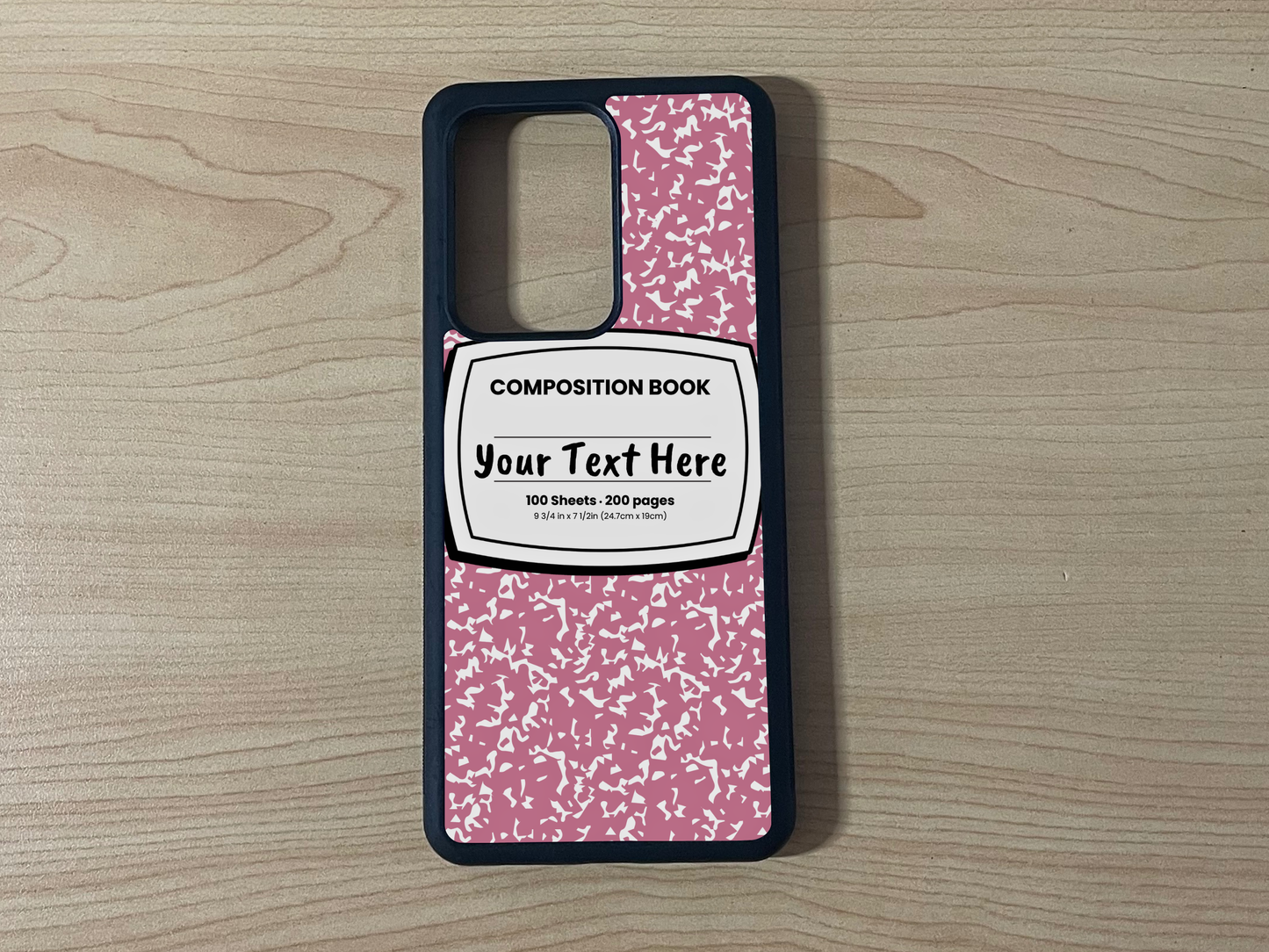 Custom phone case for the Samsung Note 20 and Note 20 Ultra with a pink and white composition notebook design with text "Your text here" on a wooden surface.
