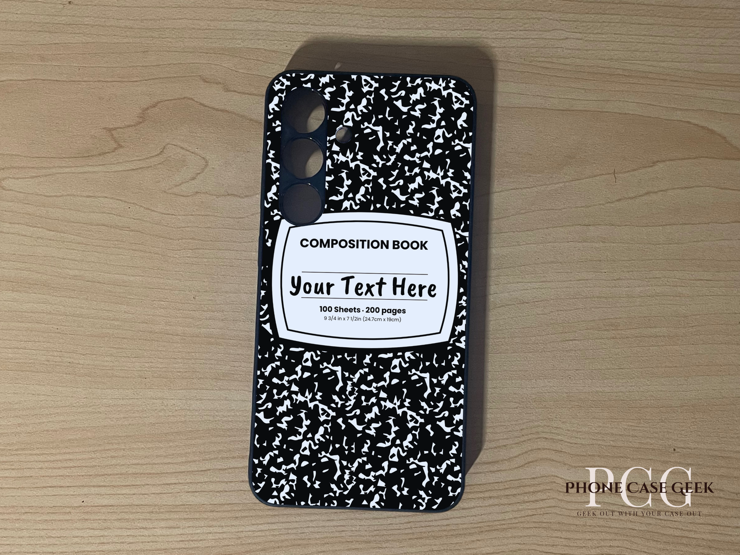 Custom phone case for the Samsung S24 and S24 Plus with a black and white composition notebook design with text "Your text here" on a wooden surface.