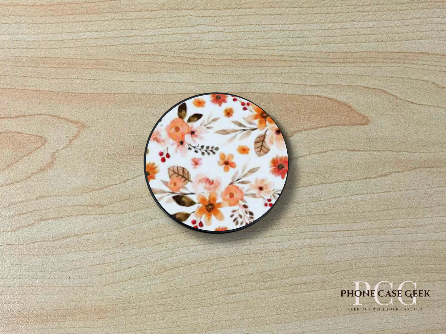 Custom adhesive phone grip with photo of a floral design on a wooden surface.
