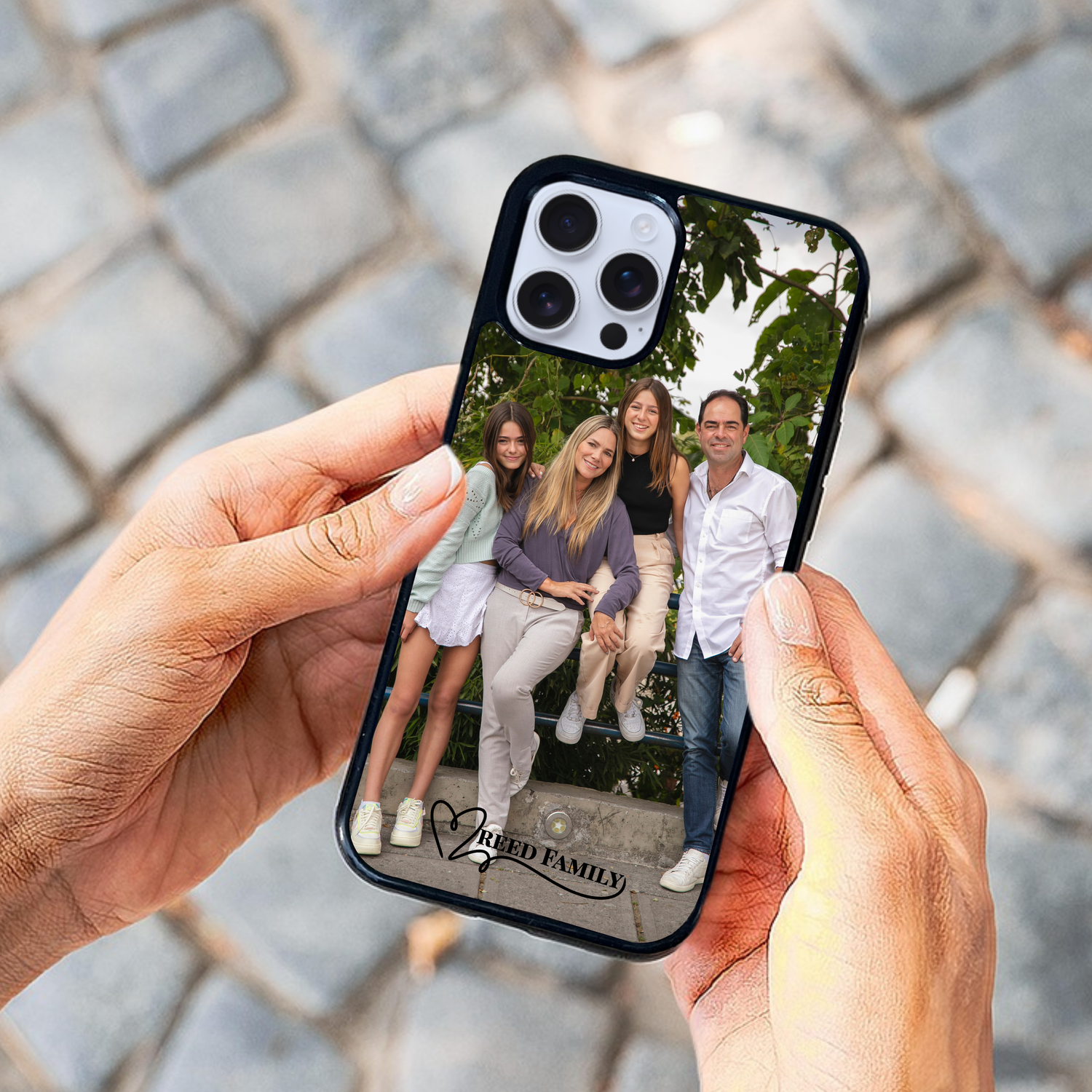 Custom phone case held by woman, featuring a family photo and personalized text that says "Reed Family" — perfect for showcasing cherished memories.