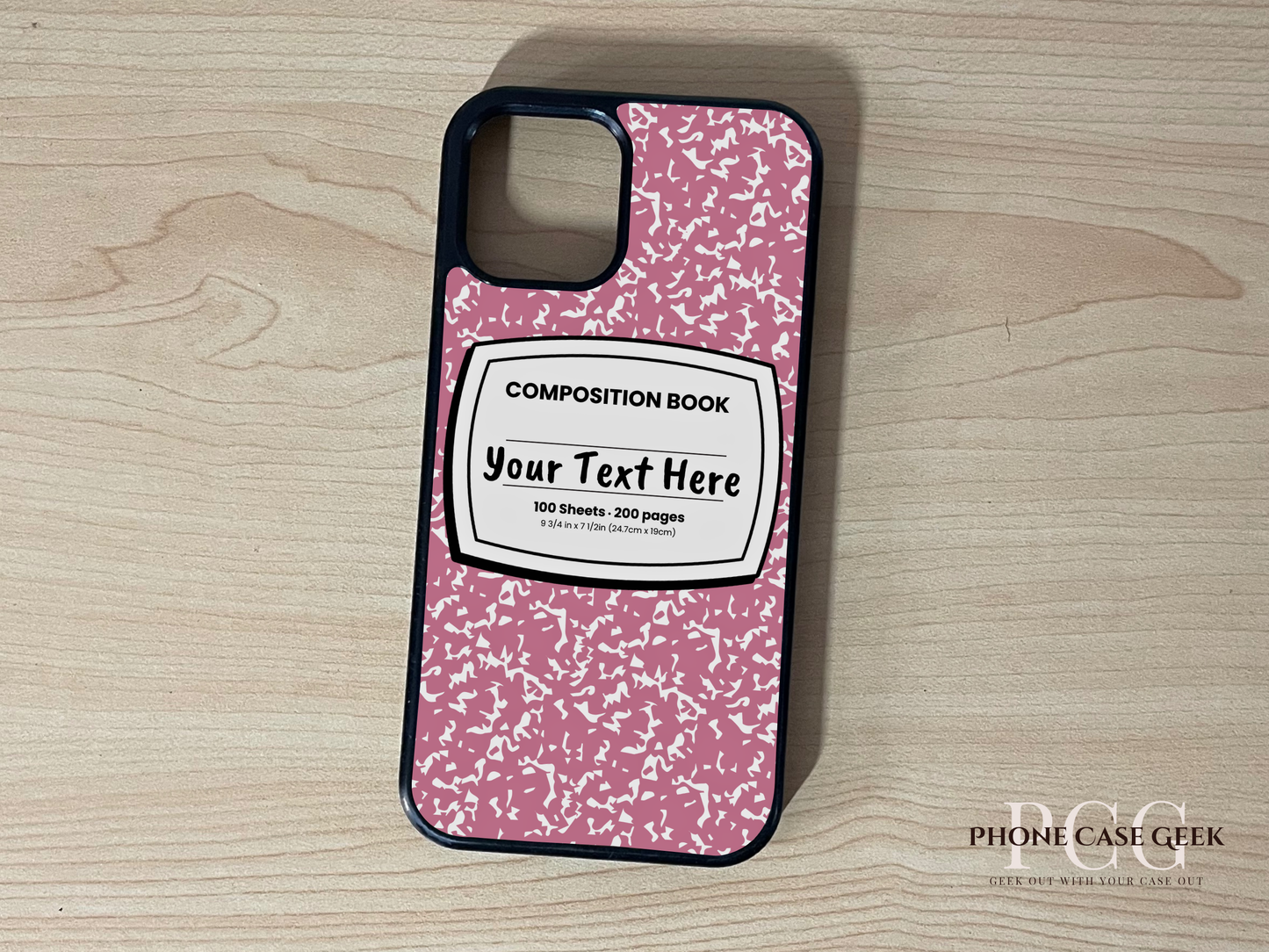 Custom iPhone case with pink and white composition book design with "Your text here" written on a wooden surface