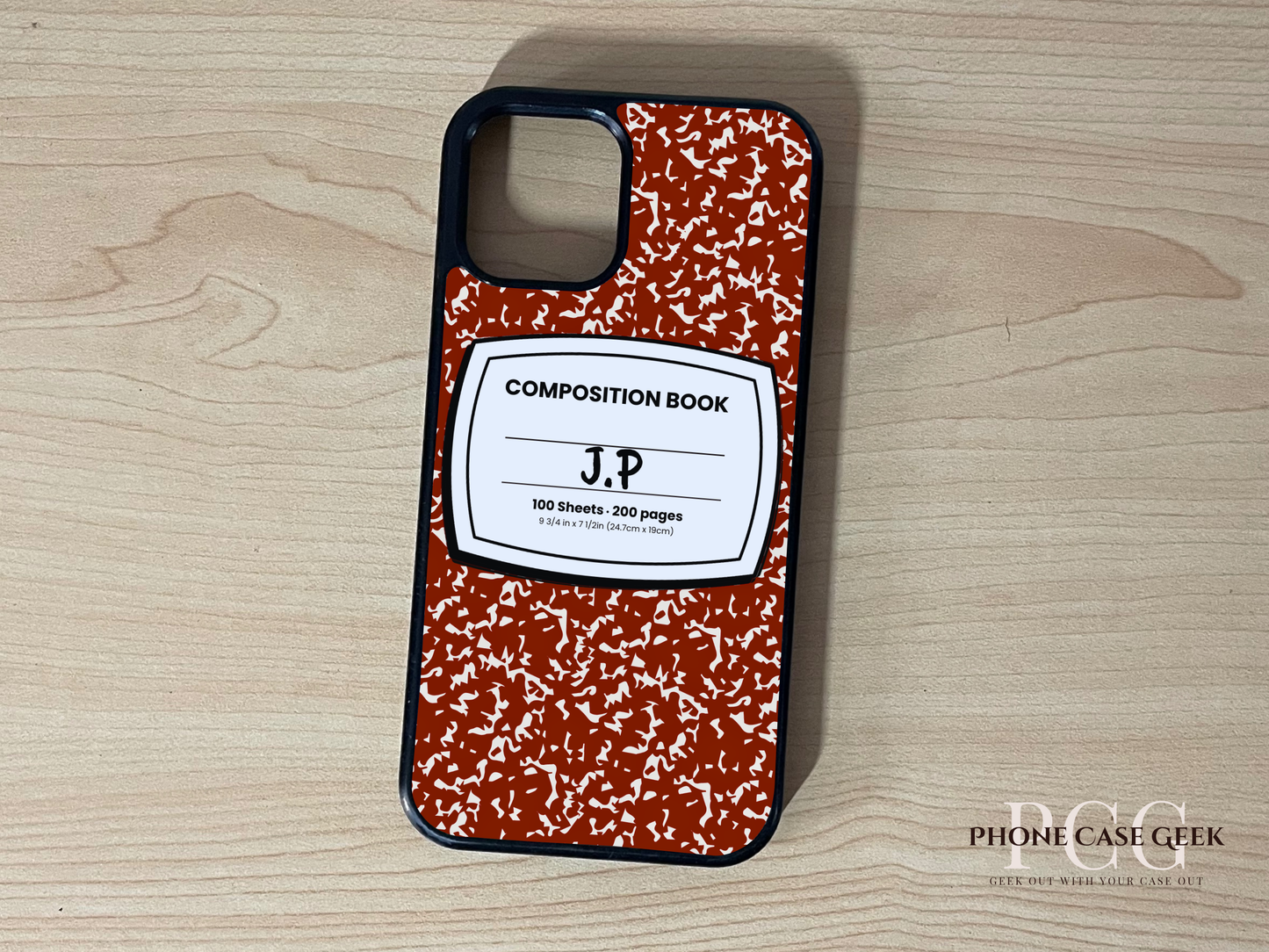 Custom iPhone case with red and white composition book design with "J.P" written on a wooden surface