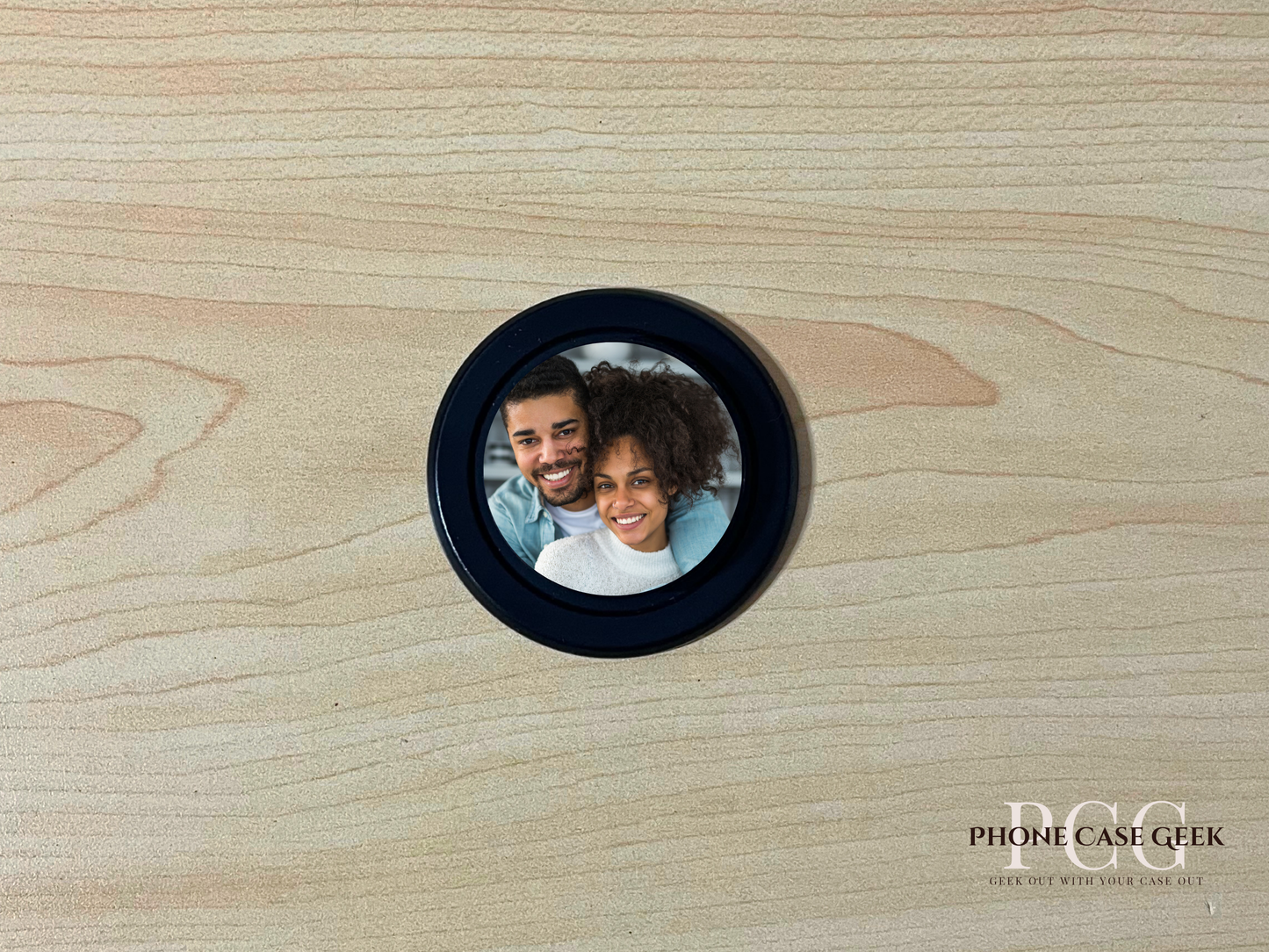 Custom black base Magsafe phone grip with photo of a couple on a wooden surface.