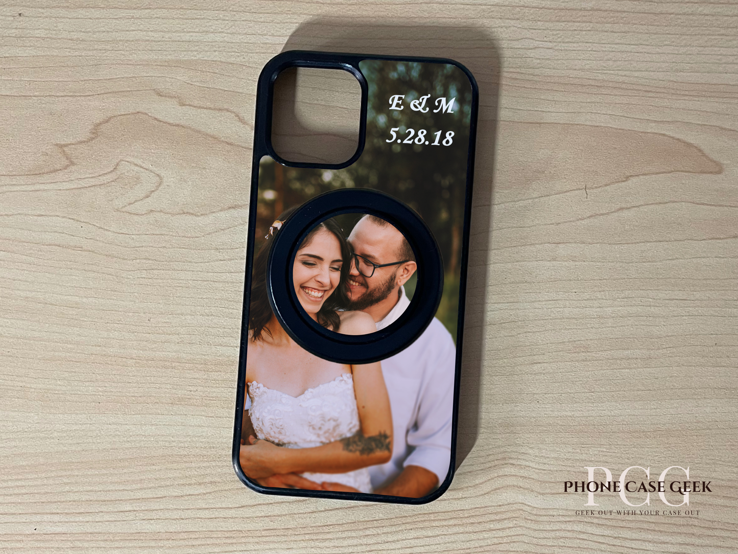 Custom Magsafe iPhone case with couple photo and initials with matching Magsafe phone grip on a wooden surface