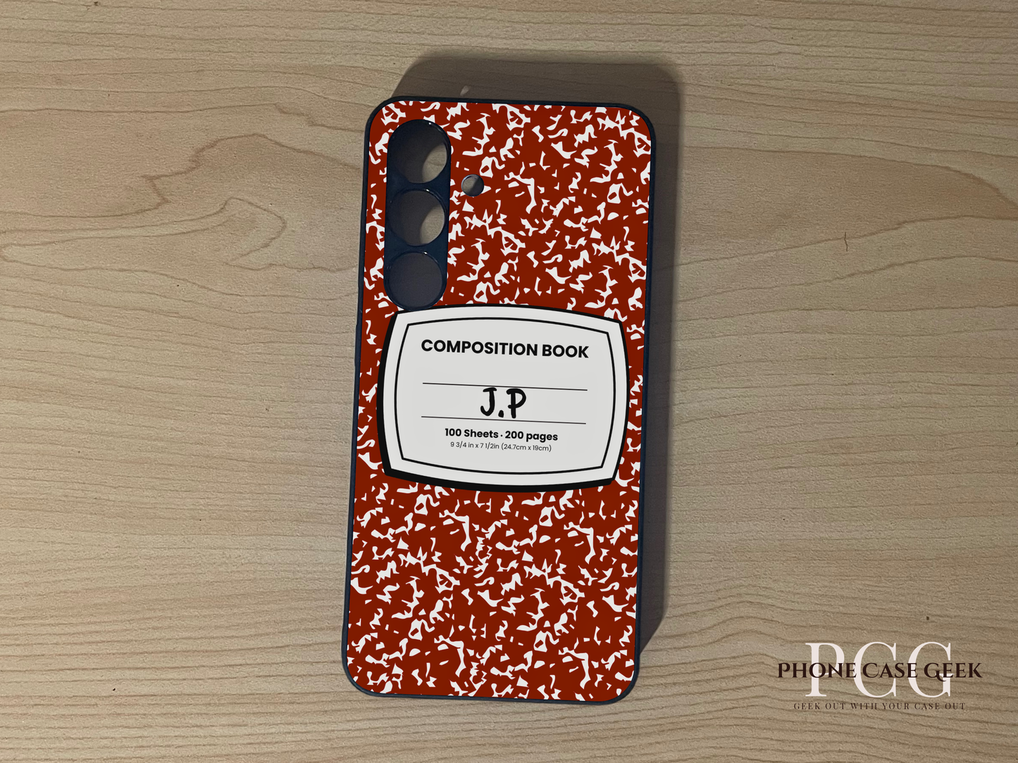 Custom Samsung S24 and S24 Plus case with red and white composition book design with "J.P" written on a wooden surface