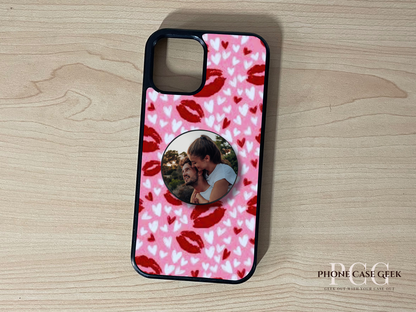 Custom iPhone case with heart design with adhesive phone grip with an image of couple attached on a wooden surface.