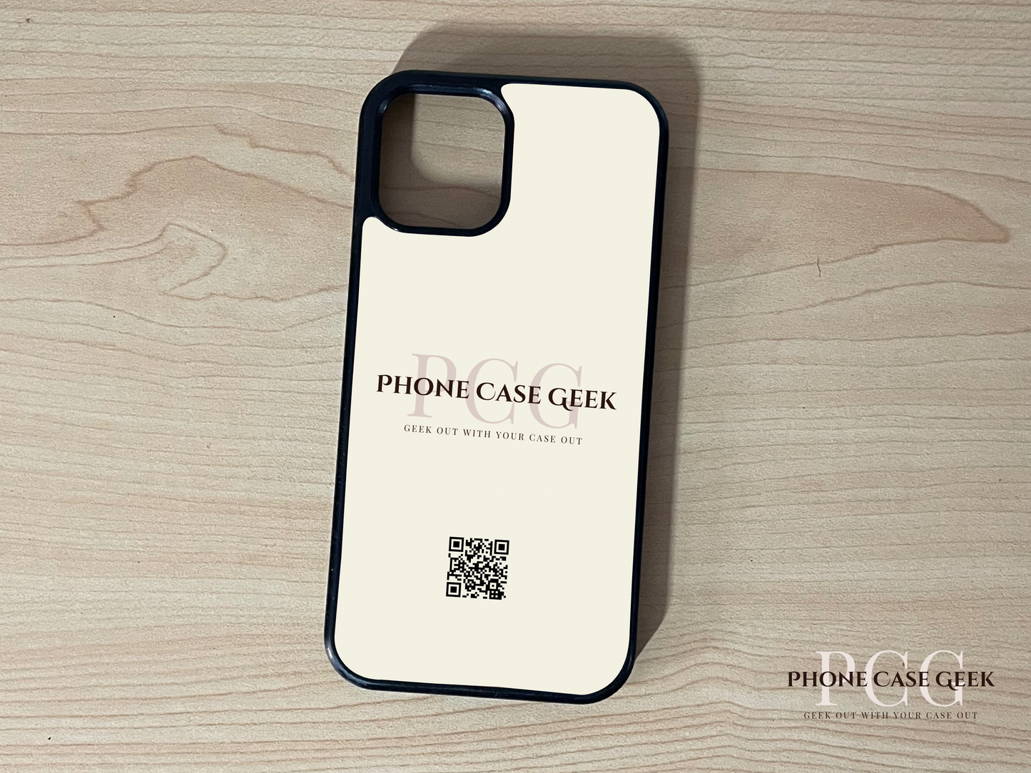 Custom phone case for the iPhone of business branding with 'Phone Case Geek' and QR code on a wooden surface.