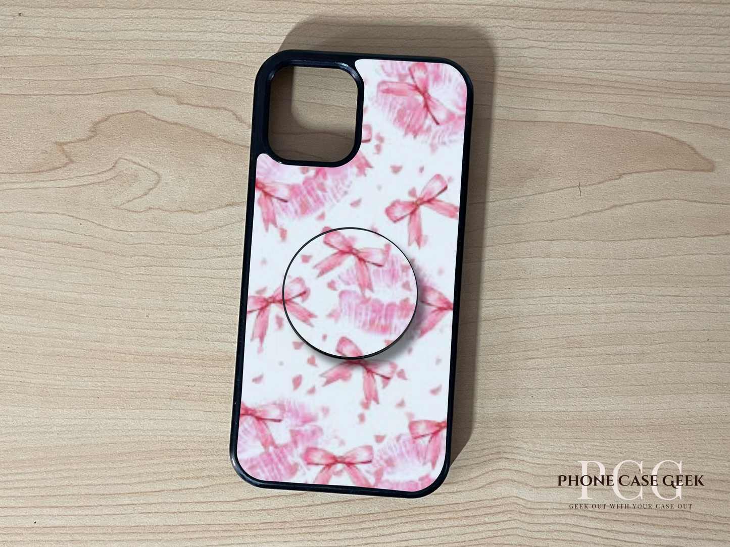 Custom iPhone case with a pink and bow design with a matching adhesive phone grip attached.