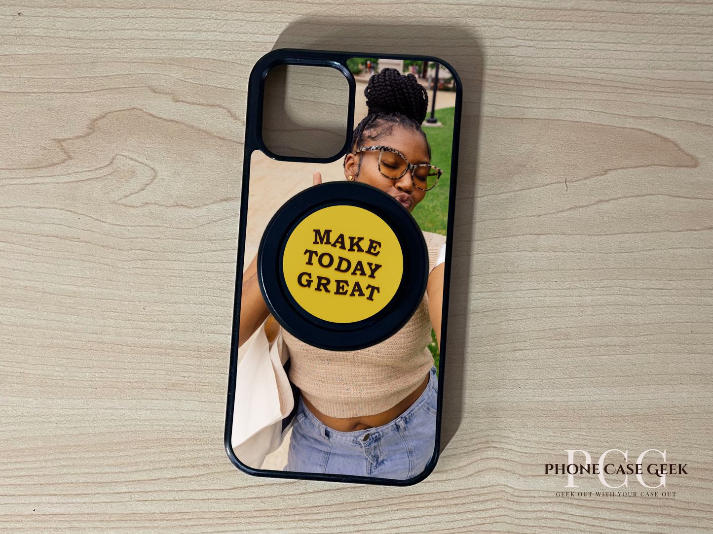 Custom Magsafe iPhone case with selfie of a woman photo and black base Magsafe custom phone grip on a wooden surface.