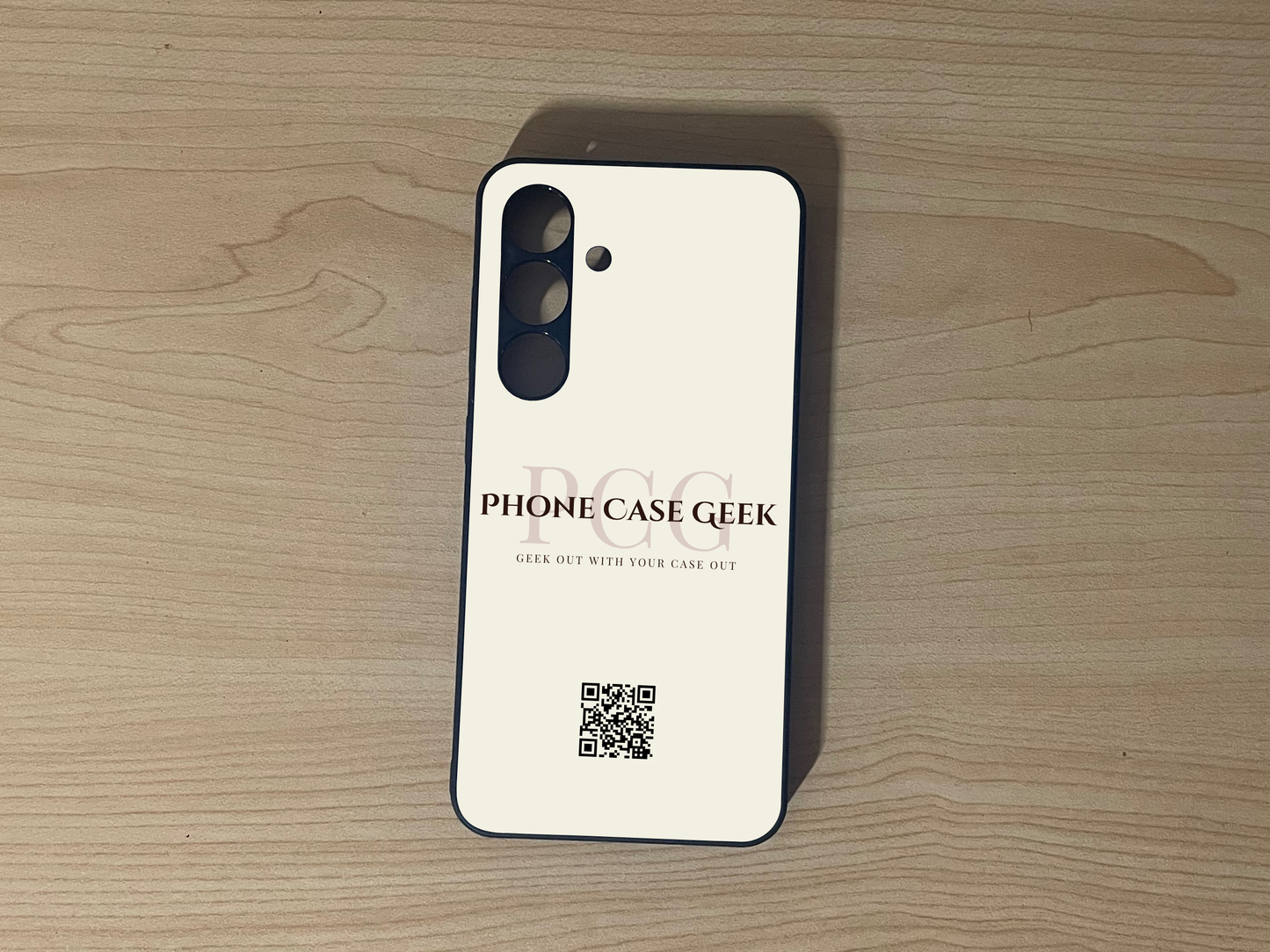 Custom phone case for Samsung S24 and S24 Plus with 'Phone Case Geek' branding to show phone case business branding design on a wooden surface