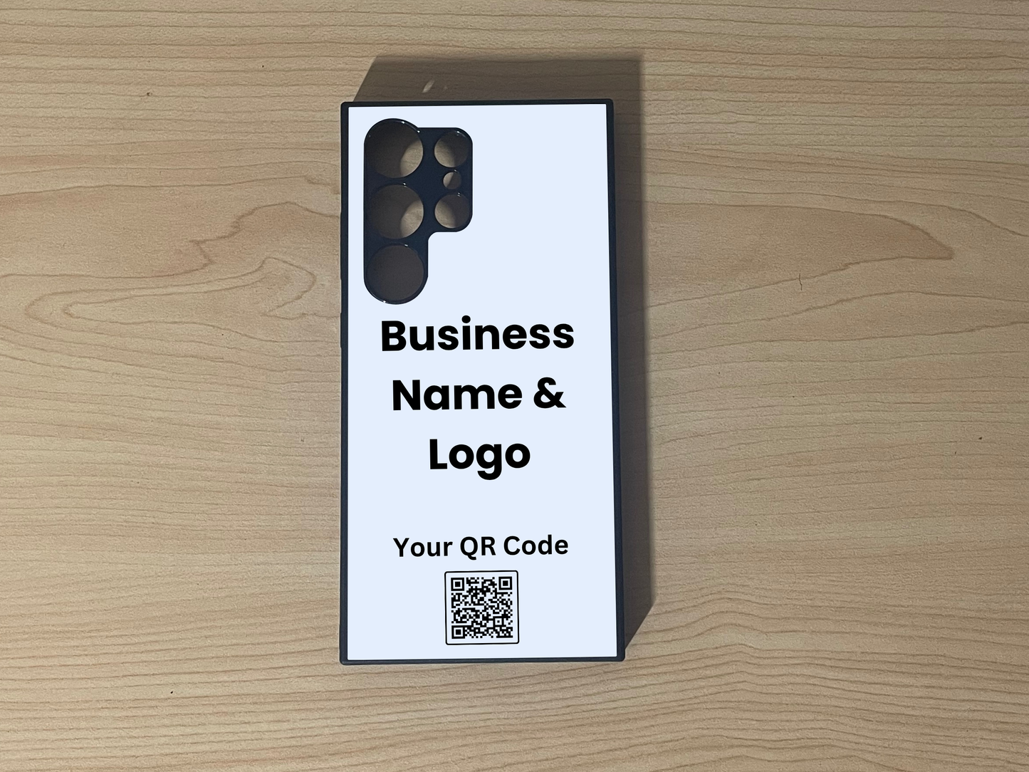 Custom phone case for the Samsung S24 Ultra, S23 Ultra and S22 Ultra showing placement for business logo design and customizable QR code on a wooden surface