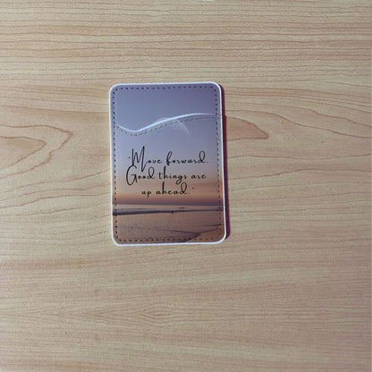 Custom phone wallet/card holder with beach image with quote design "Move forward good things are up ahead" text on a wooden surface.