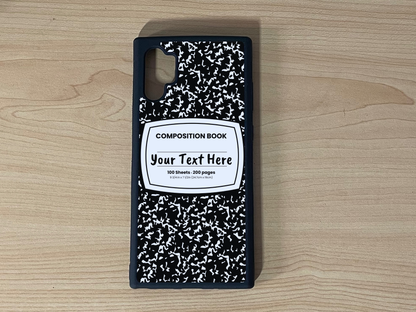 Custom phone case for the Samsung Note 10 Plus with a black and white composition notebook design with text "Your text here" on a wooden surface.