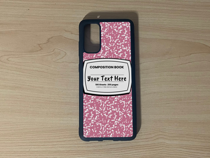 Custom phone case for the Samsung S20, S20 Ultra and S20 FE with a pink and white composition notebook design with text "Your text here" on a wooden surface.