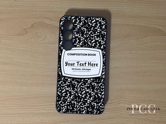 Custom phone case for the Samsung S24 and S24 Plus with a black and white composition notebook design with text "Your text here" on a wooden surface.