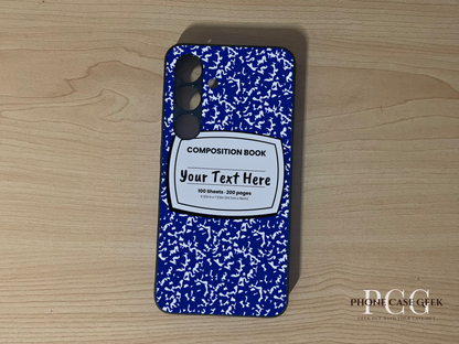 Custom phone case for the Samsung S24 and S24 Plus with a blue and white composition notebook design with text "Your text here" on a wooden surface.