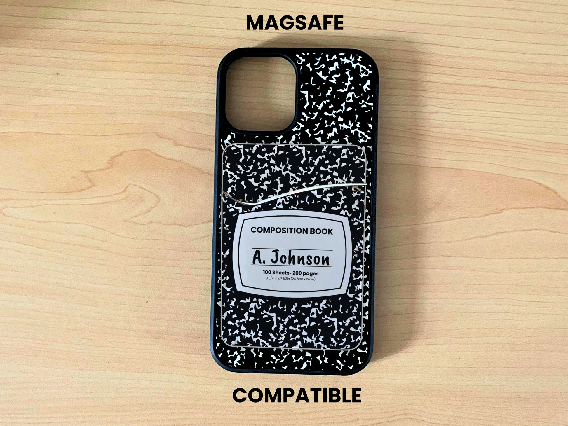 MagSafe compatible phone case with black and white composition notebook design with matching phone wallet/card holder with custom text "A. Johnson" in the middle on a wooden surface