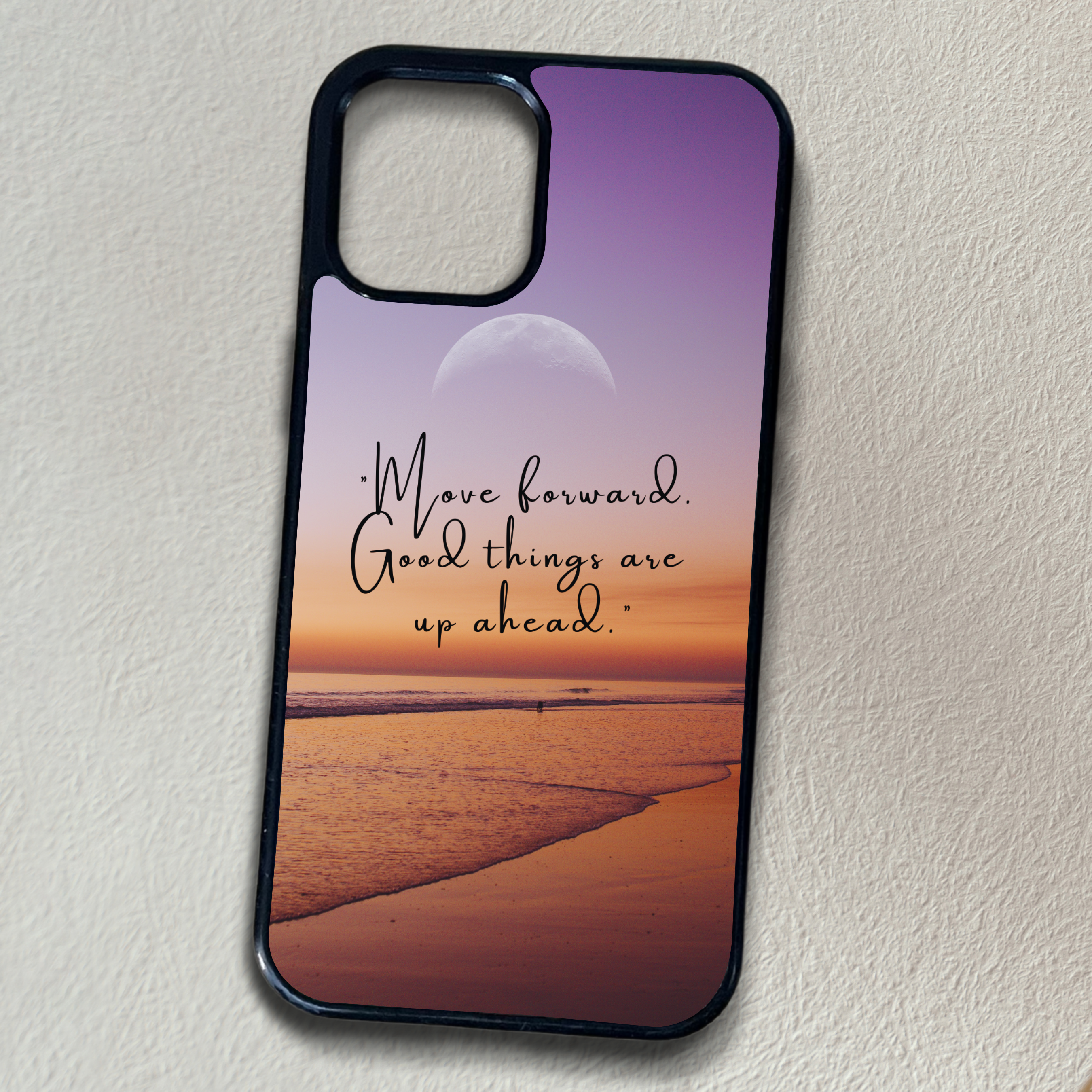 Phone case with beach scene and motivational quote saying "Move forward good things are ahead" in the center.on a plain background