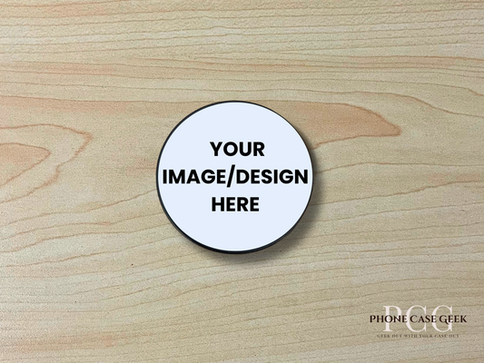 Custom adhesive phone grip with "your image here text" to show placement on a wooden surface.