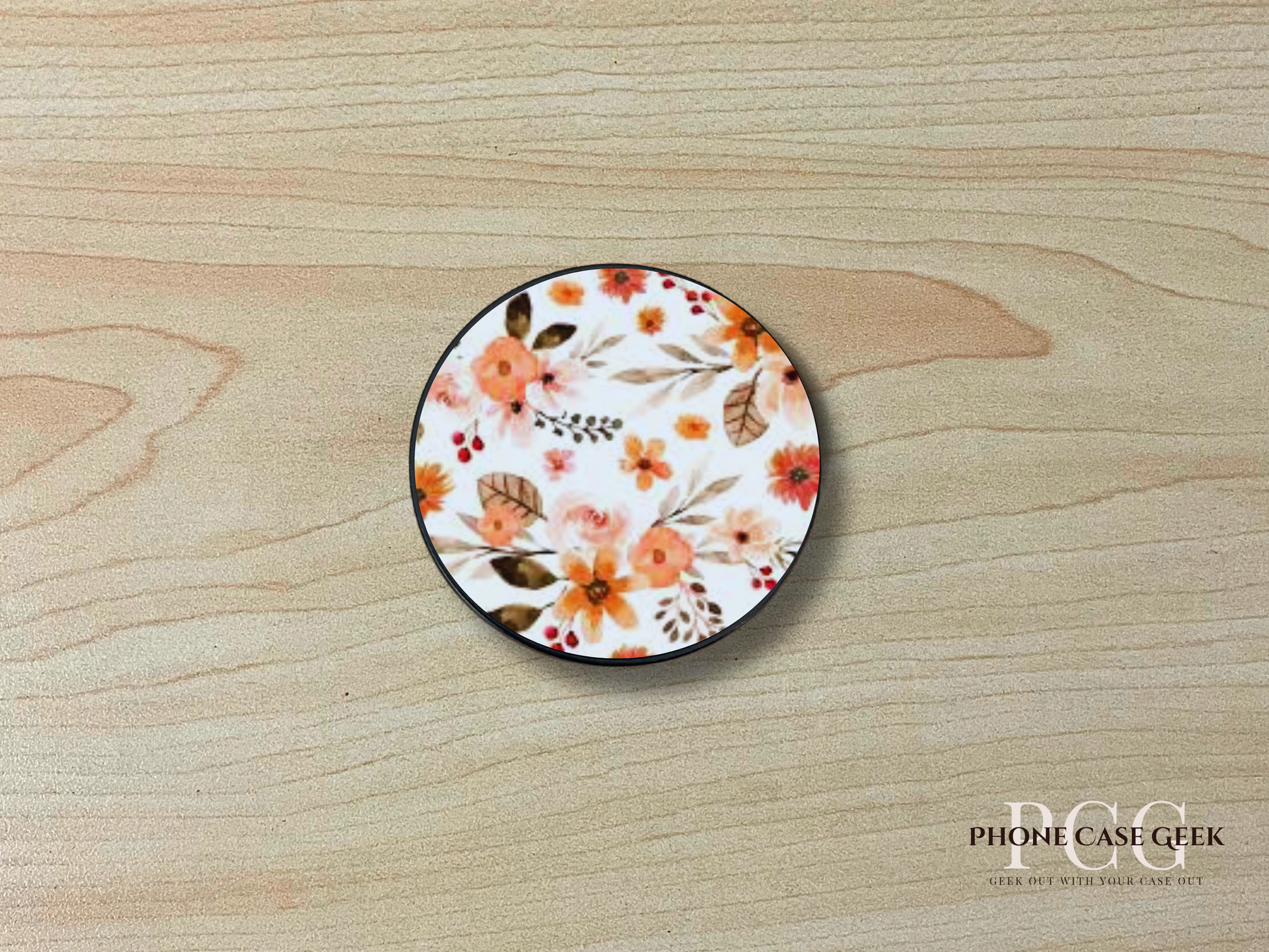Custom adhesive phone grip with photo of a floral design on a wooden surface.