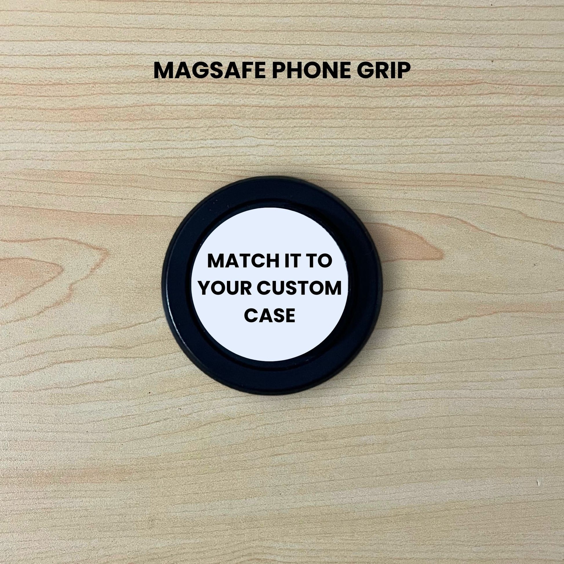 Custom black base Magsafe phone grip on a wooden surface with text "Match it to your custom case" on a wooden surface.