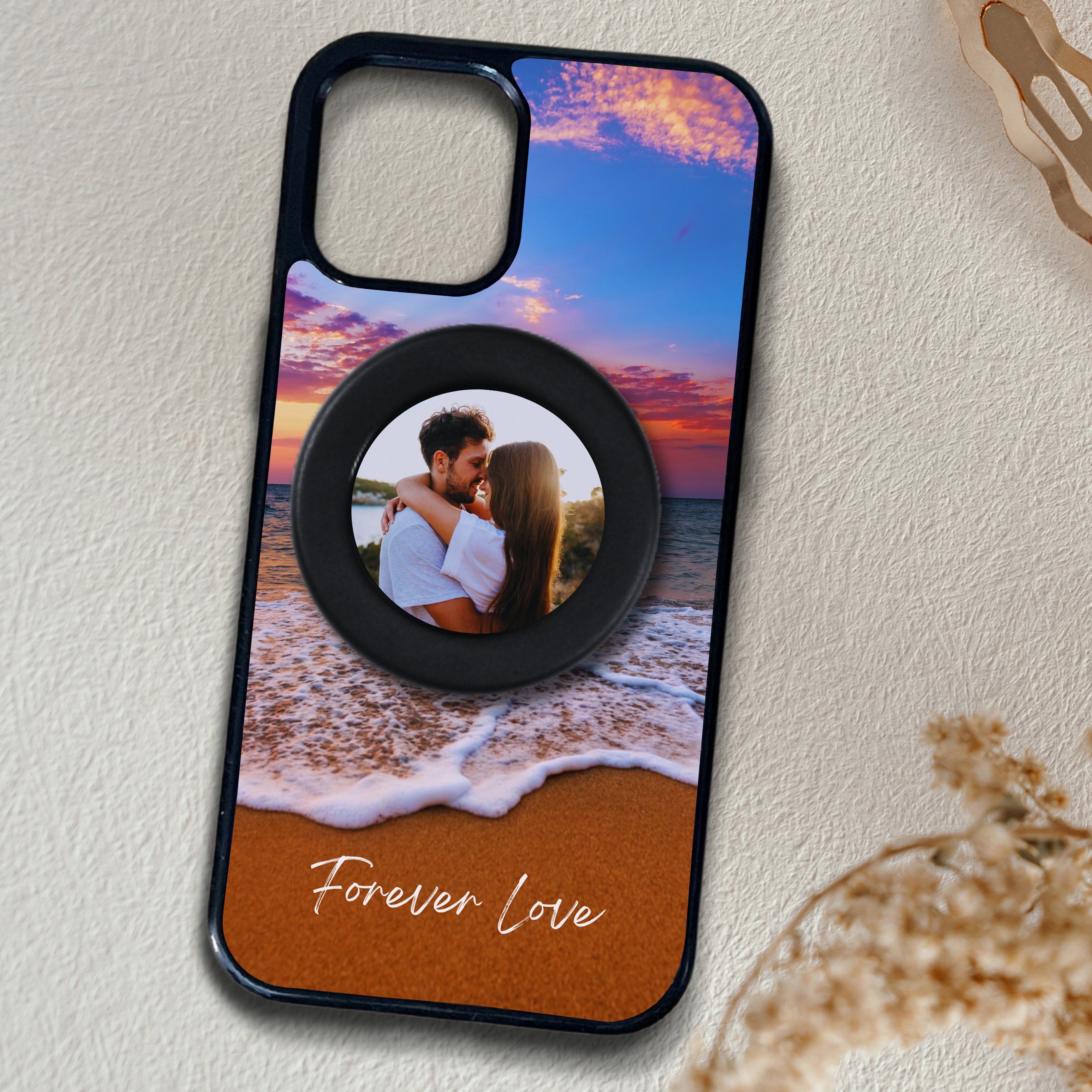 Phone case with a beach scene and 'Forever Love' text on a textured surface with a MagSafe phone grip with custom photo.
