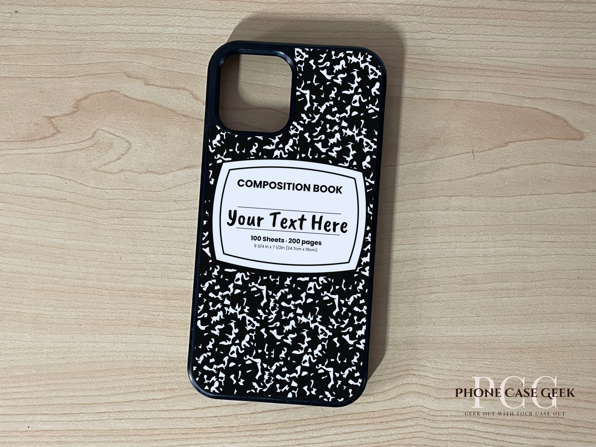 Custom iPhone case with black and white composition book design  with "Your text here" written on a wooden surface