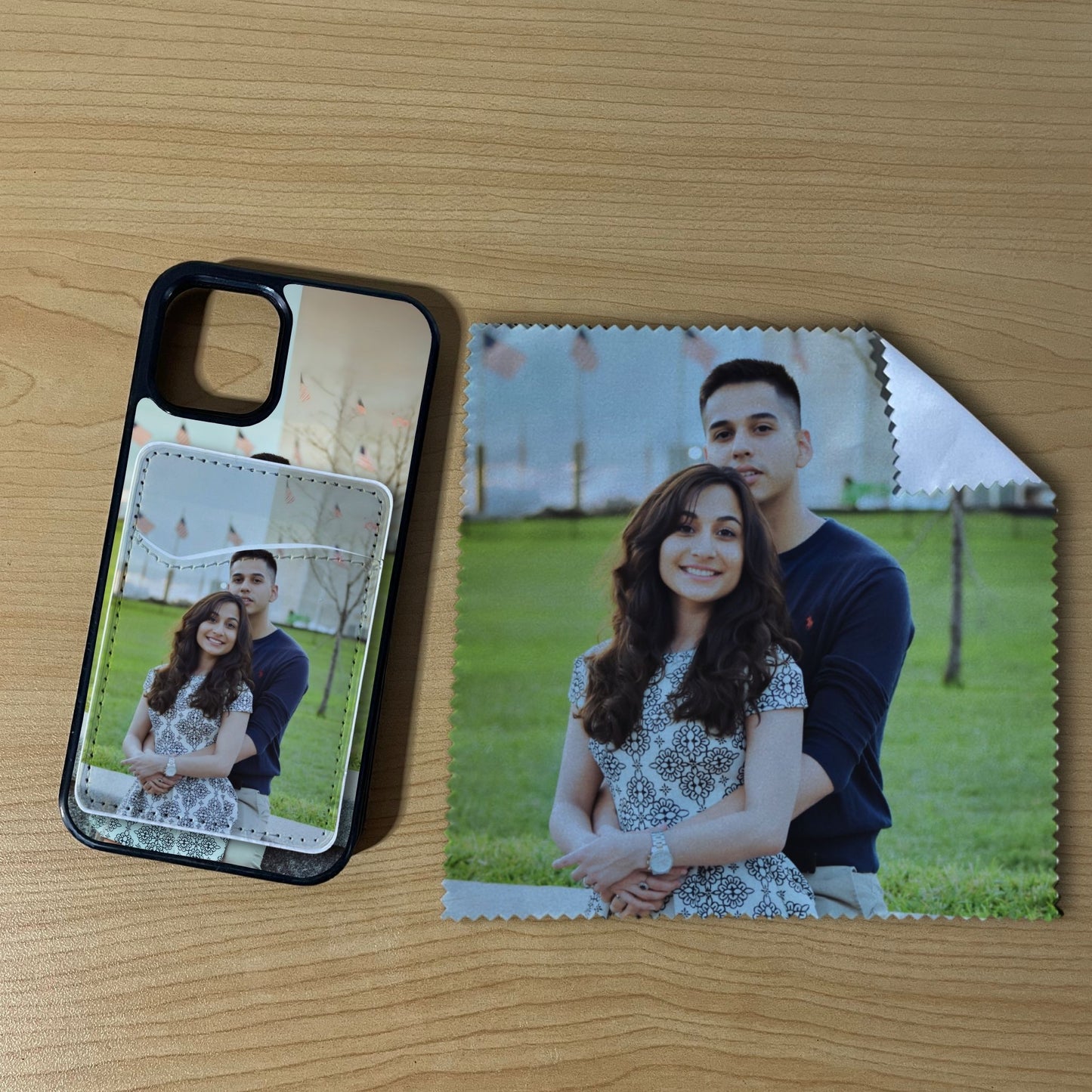 Custom iPhone case with a couple's photo with matching phone wallet card holder and matching microfiber cloth phone screen cleaner on a wooden surface