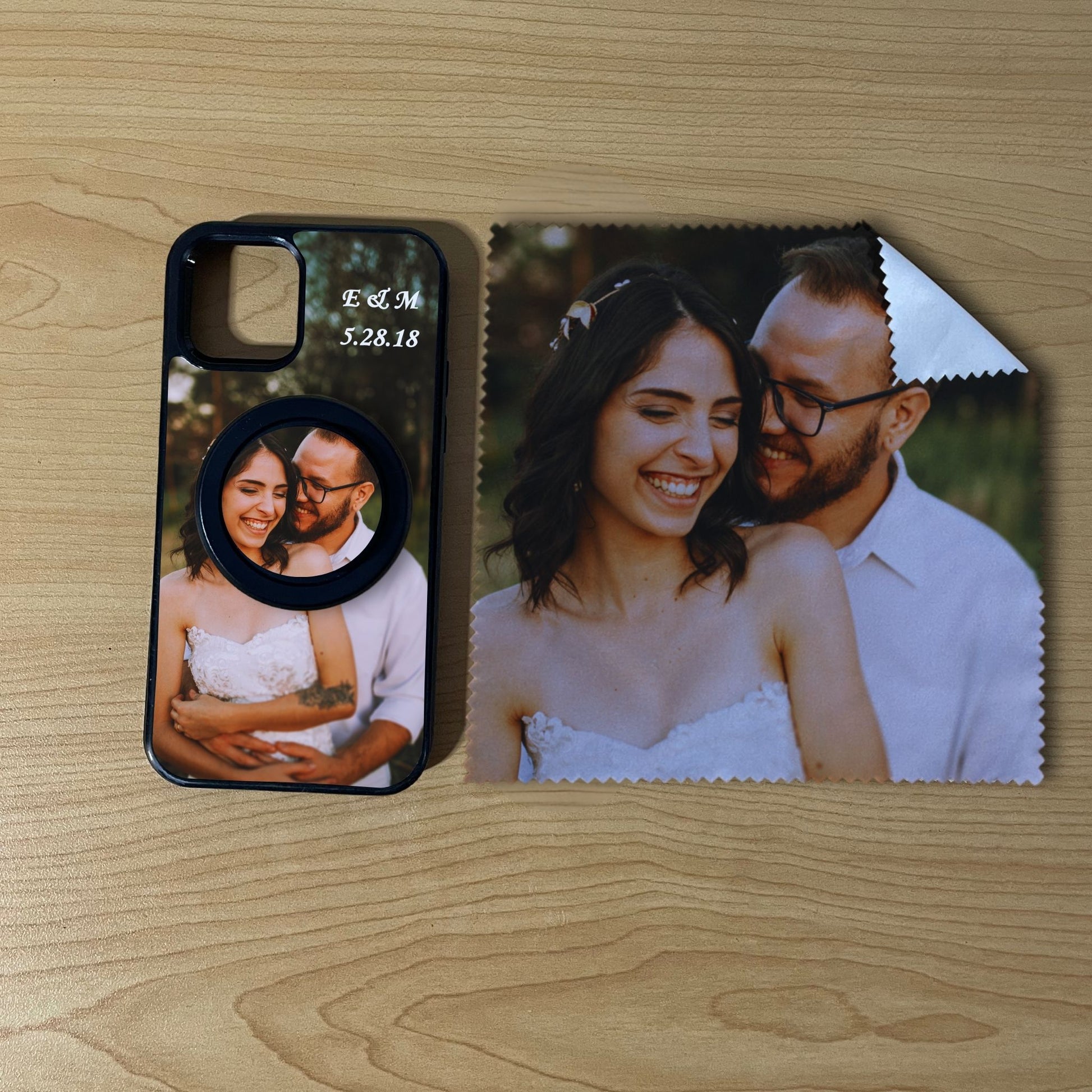 Custom MagSafe iPhone case bundle set with couples photo design with matching black phone grip and matching microfiber cloth phone screen cleaner on a wooden surface.