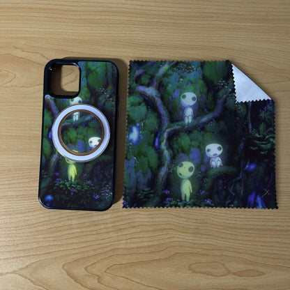 Custom MagSafe iPhone case bundle set with forest design with matching black phone grip and matching microfiber cloth phone screen cleaner on a wooden surface.