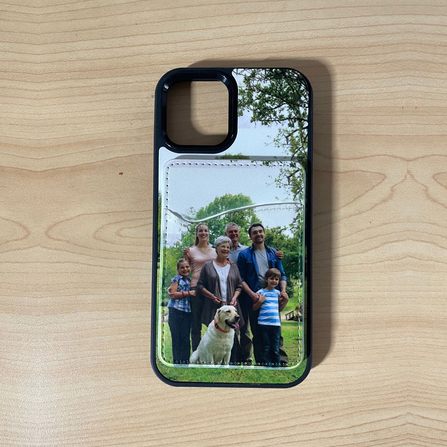 Custom phone case with a family photo and matching phone card holder attached on a wooden surface