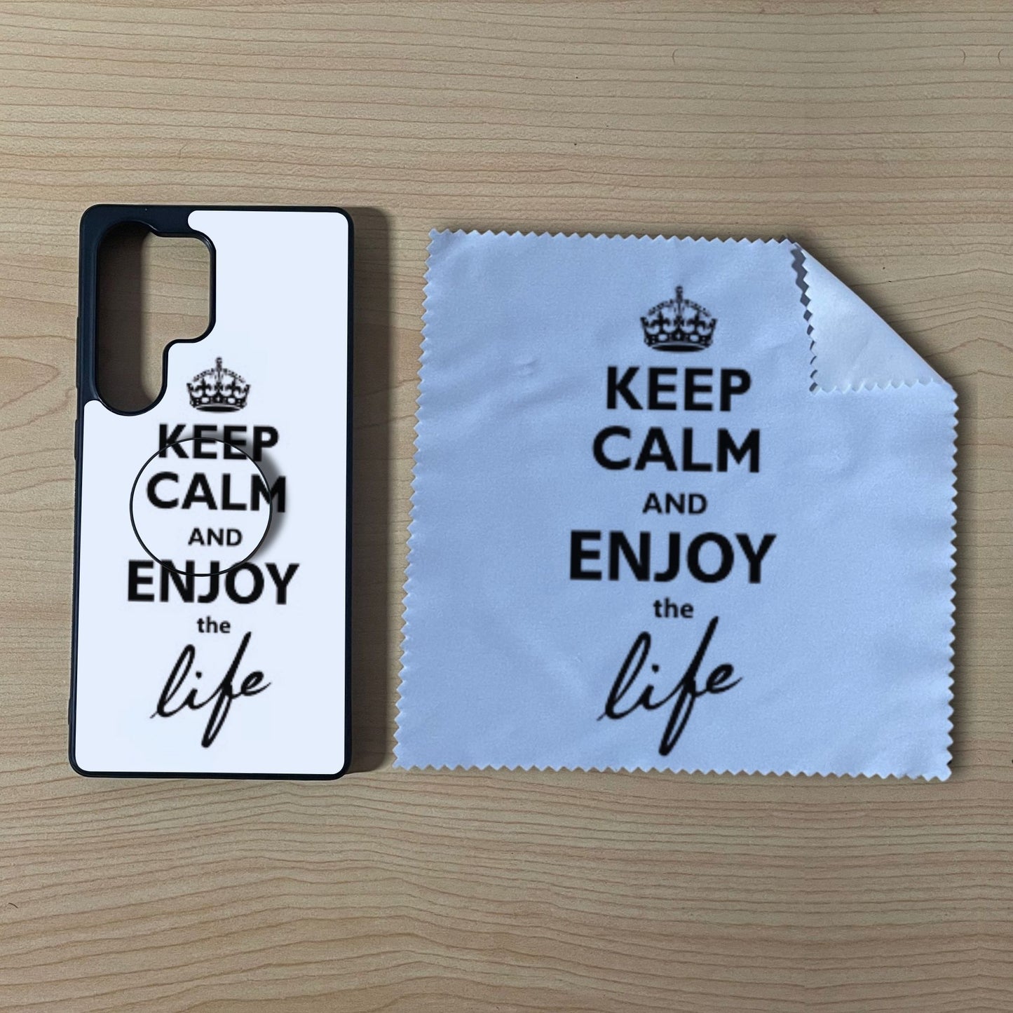 Custom Samsung case bundle set with matching phone grip and cleaning microfiber cloth with "Keep calm and enjoy the life" text design on a wooden surface