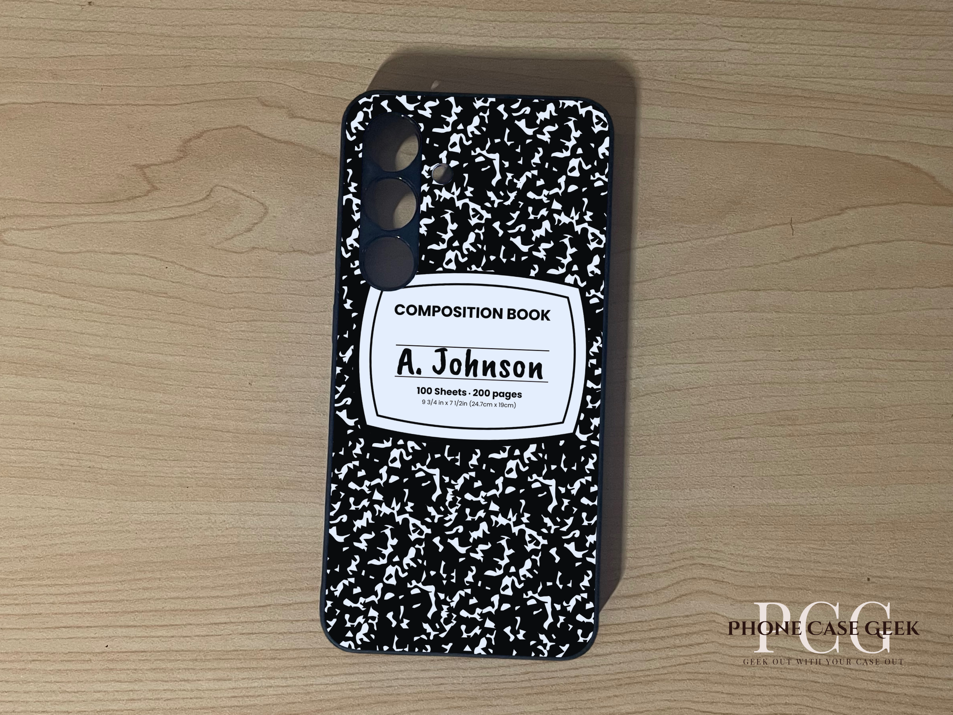 Custom Samsung S24 and S24 Plus case with black and white composition book design  with "A. Johnson" written on a wooden surface