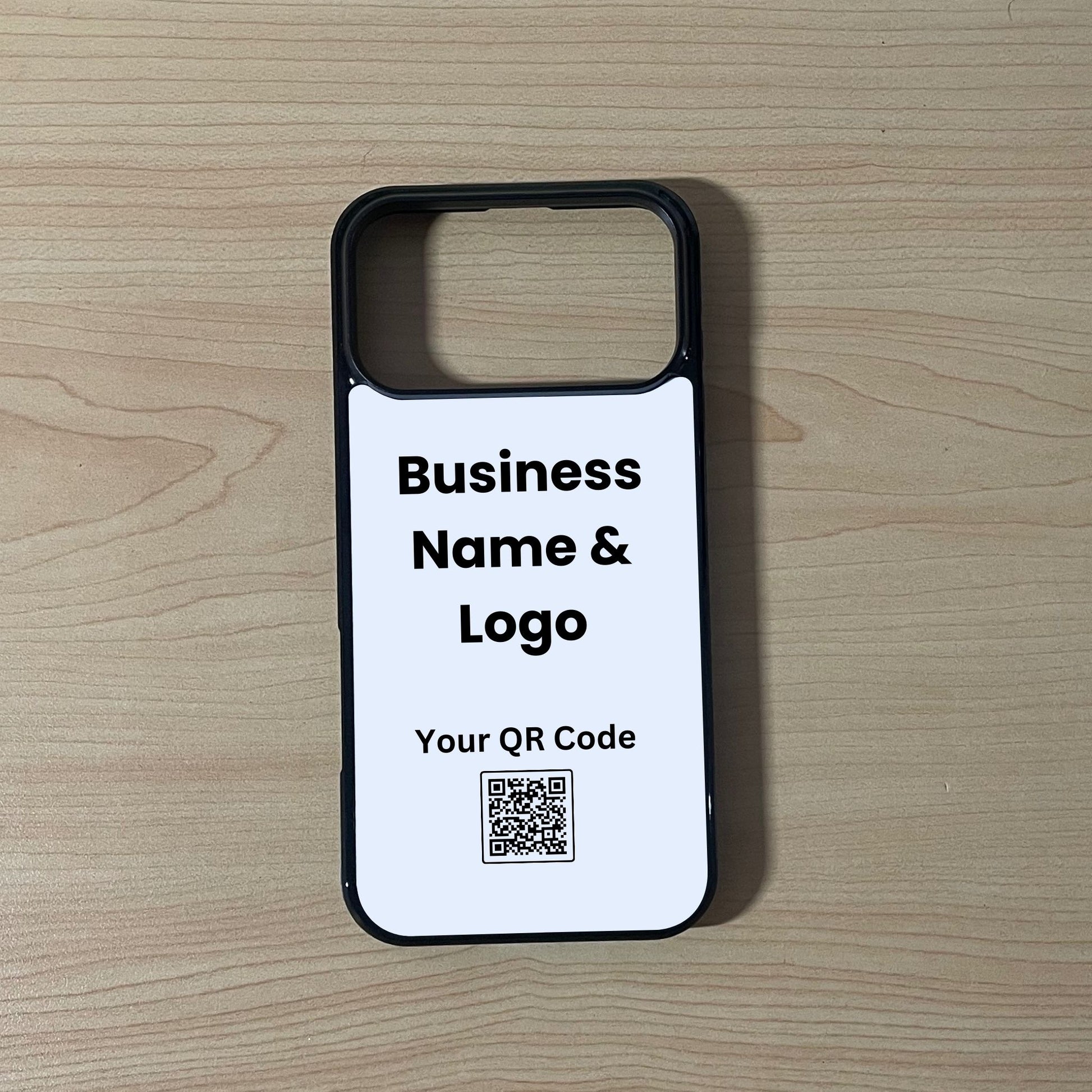 Custom phone case for the iPhone 17 Pro and 17 Pro Max showing qr code and business logo  placement on a wooden surface.