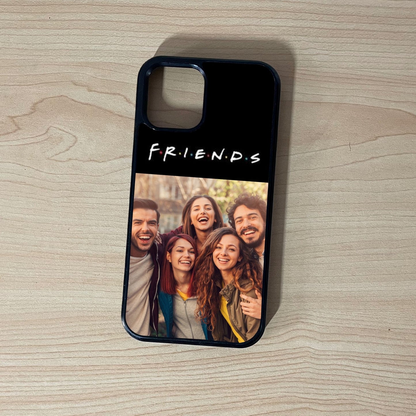 Custom phone case for the iPhone showing 2 photo collage photo of the text "Friends" and friend group moments on a wooden surface.