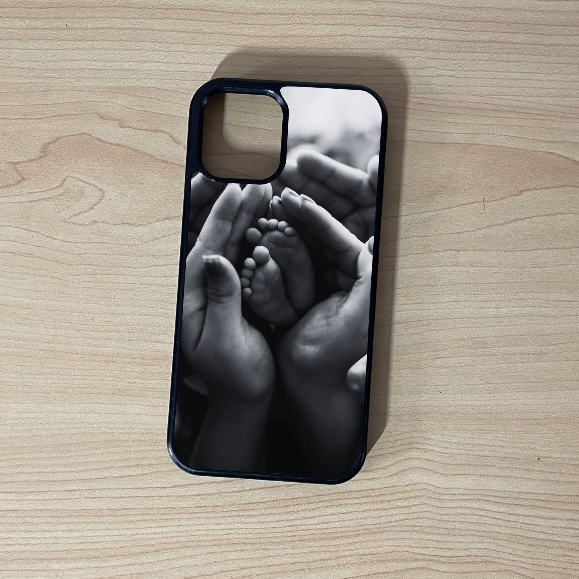 Custom iPhone case of photo of with hands holding baby feet design on a wooden surface