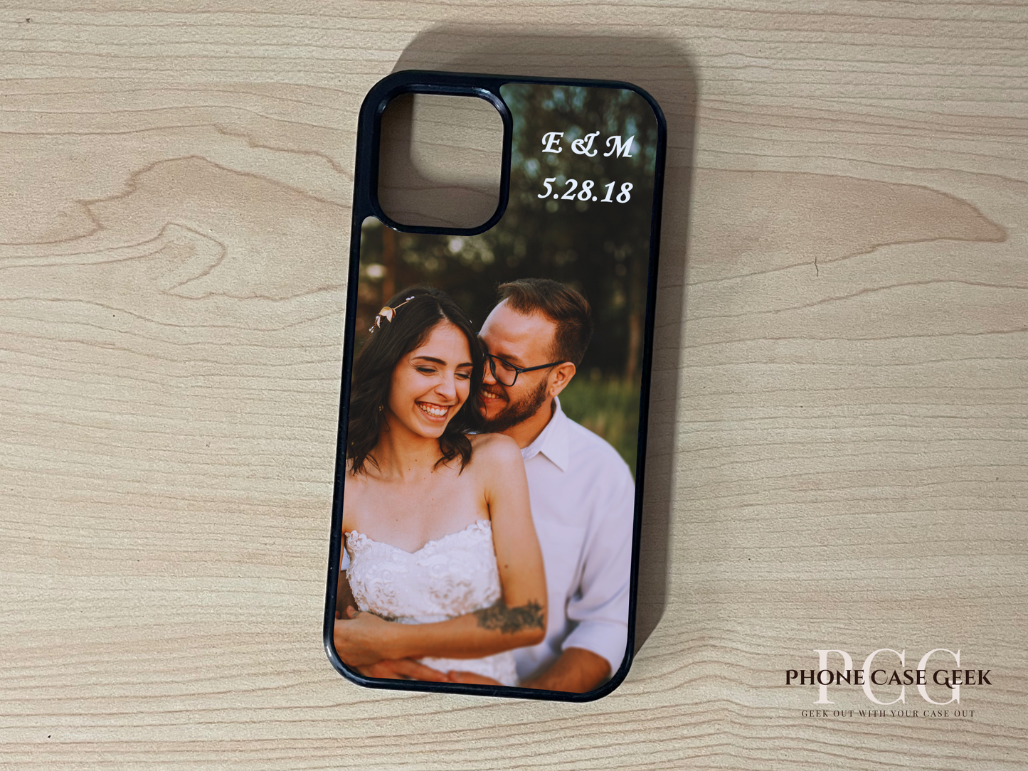 Custom phone case with a couple's photo and initials on a wooden surface