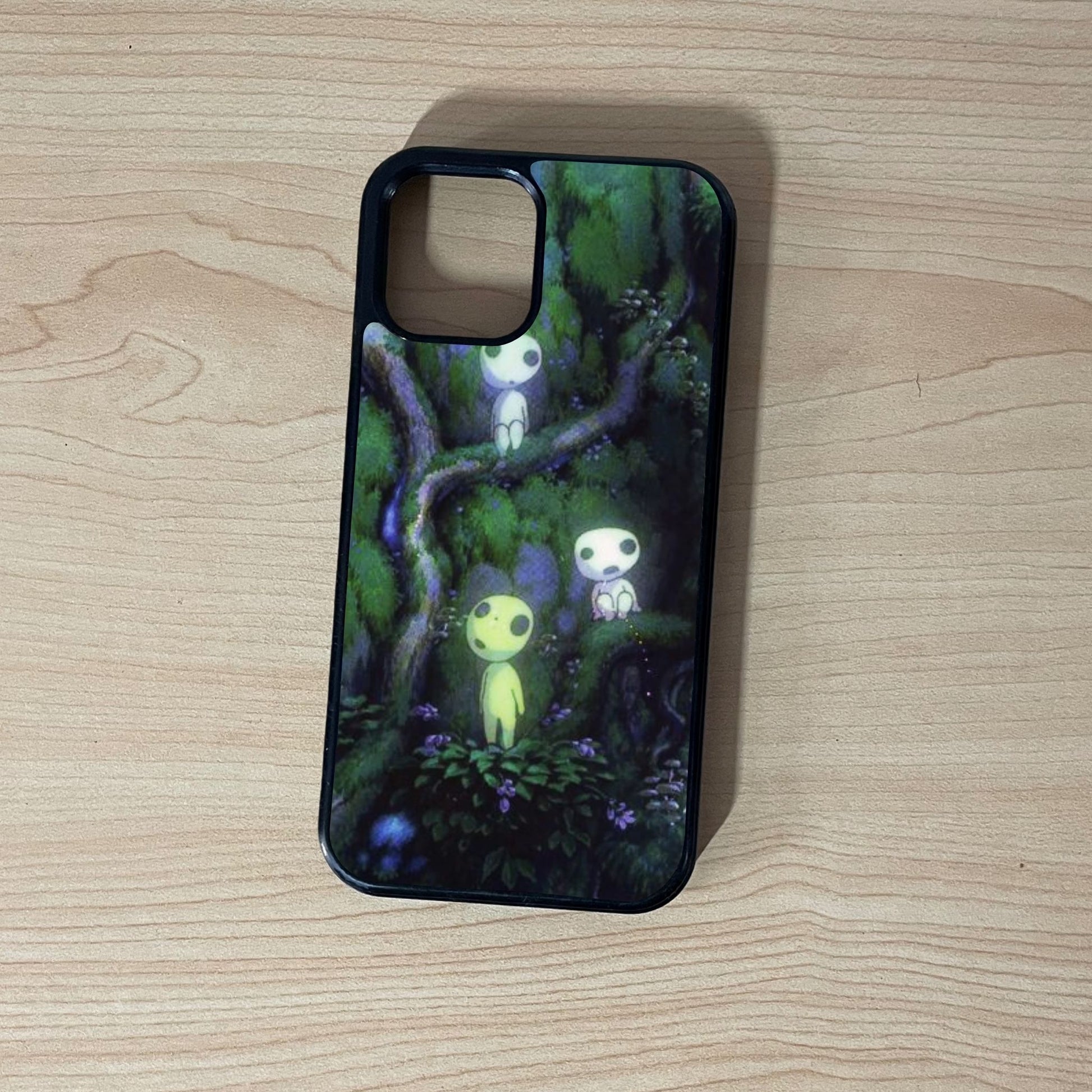 Custom iPhone case with an image of a beautiful forest with  forest spirit characters on a wooden surface.