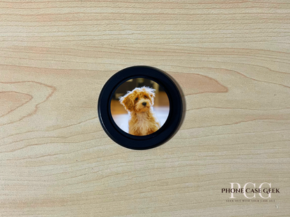 Custom black base Magsafe phone grip with photo of a couple on a wooden surface.