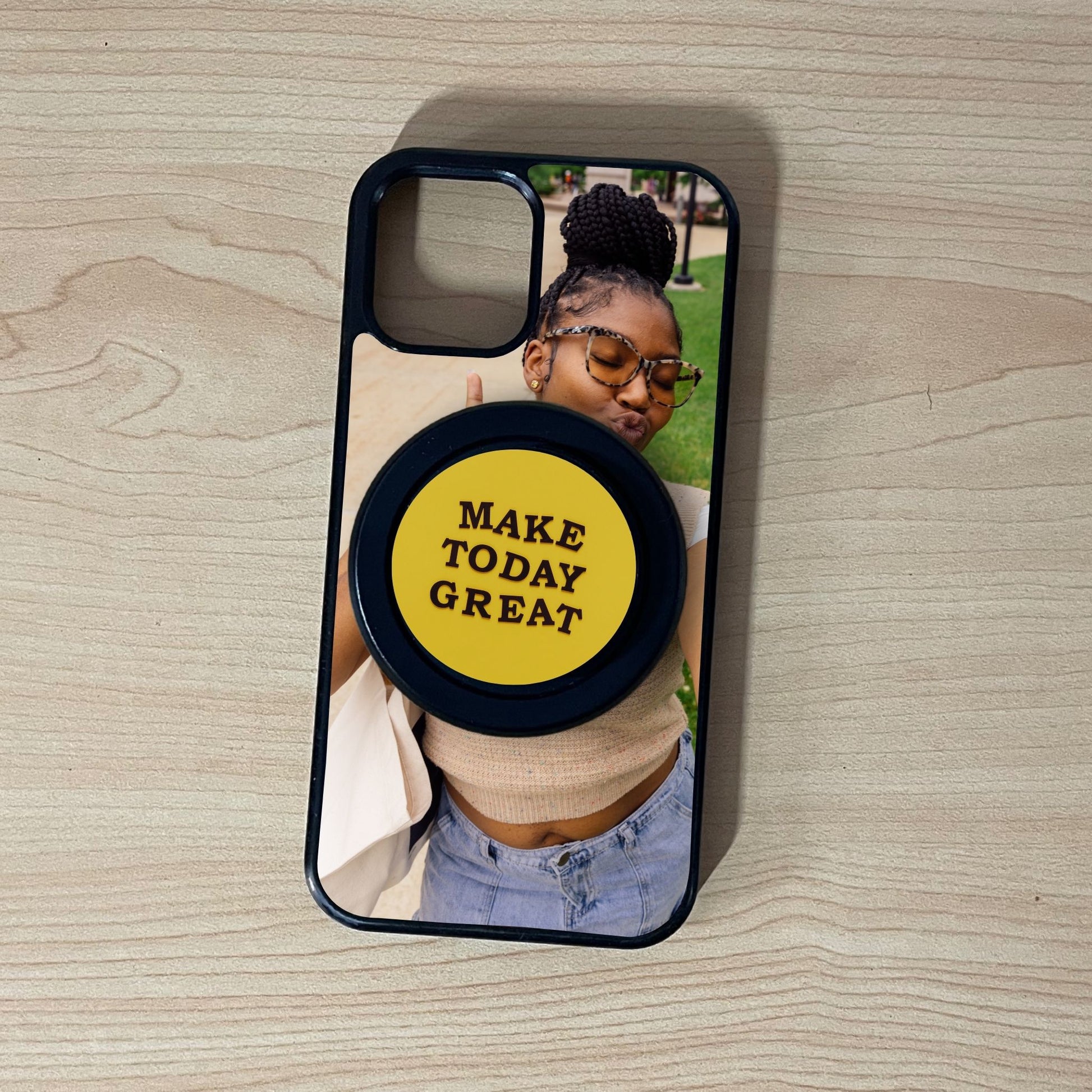 Custom Magsafe iPhone case with selfie of a woman photo and black base Magsafe custom phone grip on a wooden surface.