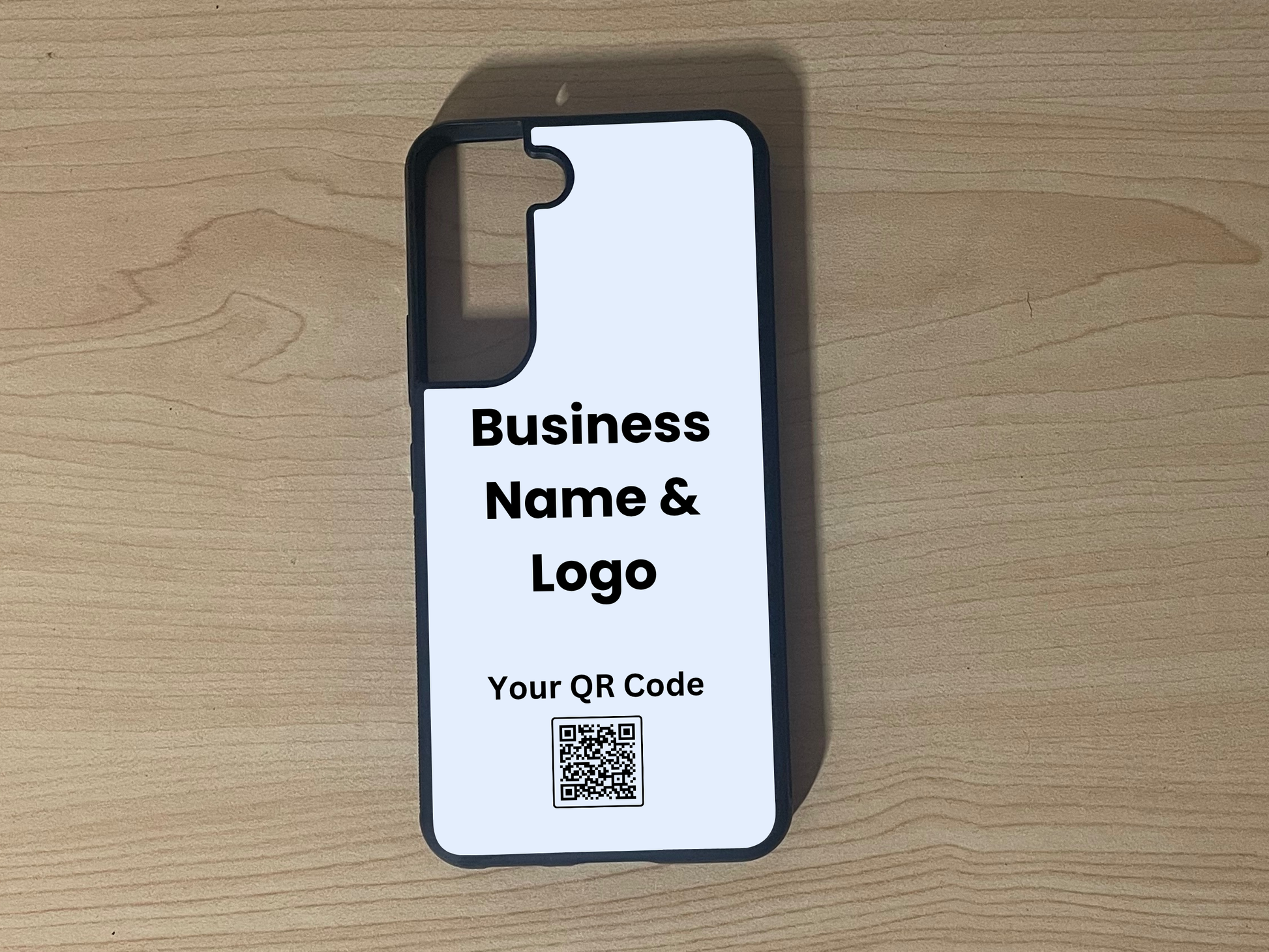 Custom phone case for the Samsung S21 and S21 Plus showing  placement for business logo design and customizable QR code on a wooden surface