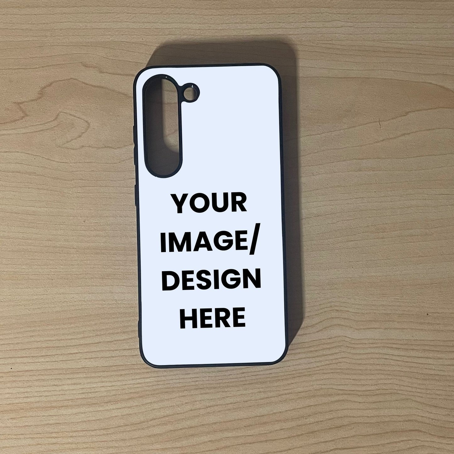 Custom phone case for Samsung S23 and S23 Plus with 'Your Image/Design Here' text on a wooden surface to show customization.