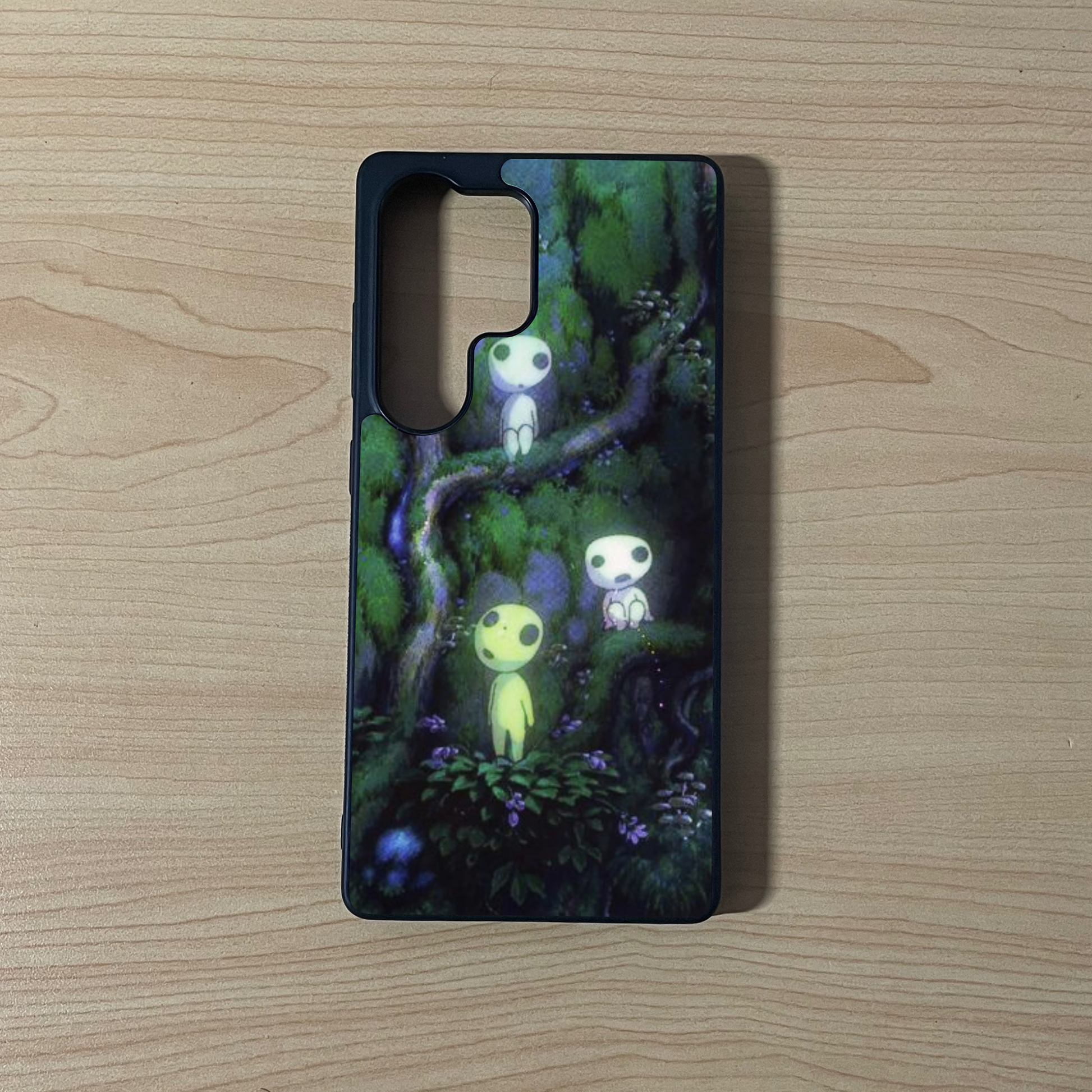 Samsung S25 Ultra custom iPhone case with an image of a beautiful forest with  forest spirit characters on a wooden surface.
